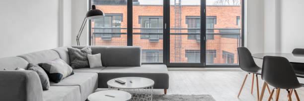 istock Bright living room with big windows, panorama 1286494595