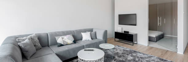 istock Living room with big corner sofa, panorama 1286494603
