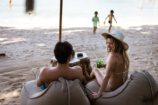 istock Happy romantic couple enjoying beautiful sunset at the beach 1286495150