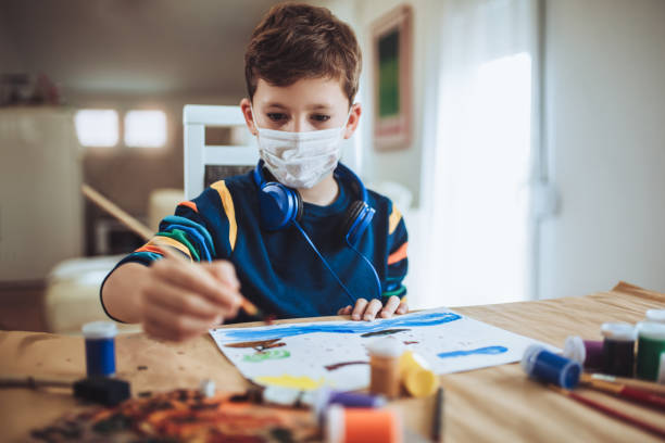 istock Cute little boy painting a picture in home studio 1286495709