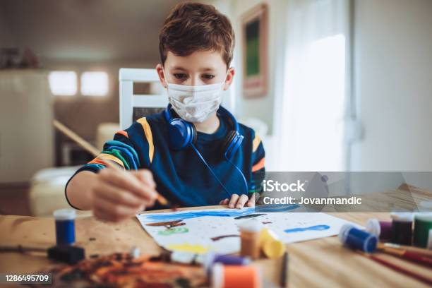 Cute Little Boy Painting A Picture In Home Studio Stock Photo - Download Image Now - Child, Protective Face Mask, Boys