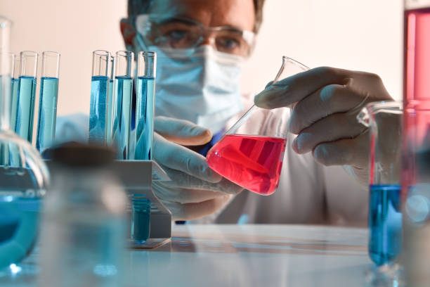 istock Detail chemist looking carefully a flask on a laboratory 1286495873