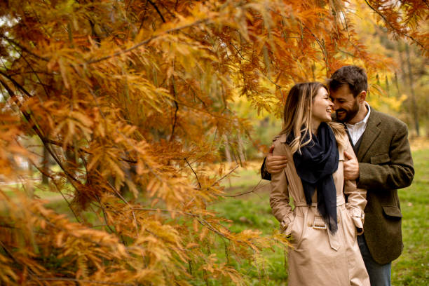 istock Young couple walking in the autumn park 1286498081