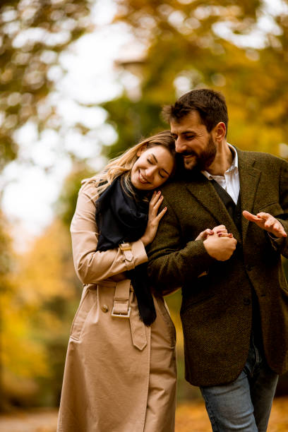 istock Young couple walking in the autumn park 1286498108