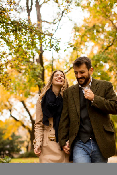 istock Young couple walking in the autumn park 1286498167