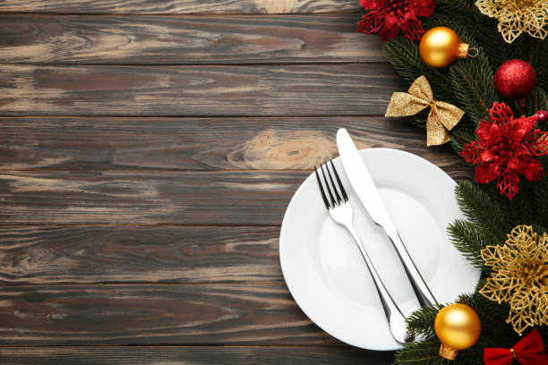 istock Christmas table place setting with decoration on brown. Holidays background 1286502618