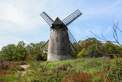 A photograph of bidston hill windmill , The current building was built around 1800 and continued working as a flour mill until about 1875.After falling into disuse the windmill and the land, on which it stands, was purchased by Birkenhead Corporation and restored from 1894.
