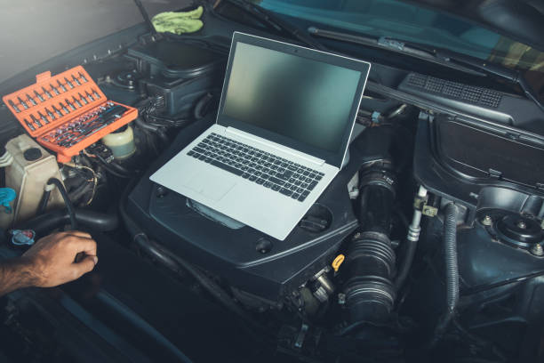 istock Professional car mechanic working in auto repair service using laptop 1286506931