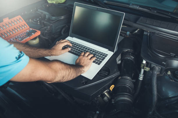 istock Professional car mechanic working in auto repair service using laptop 1286506935