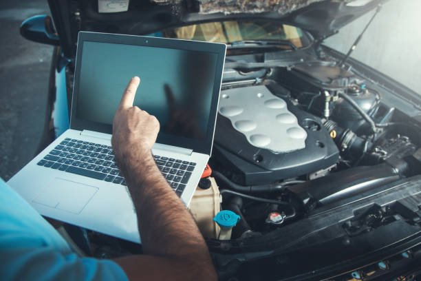 istock Professional car mechanic working in auto repair service using laptop 1286506937