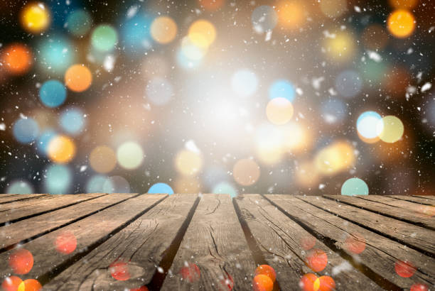 istock Abstract Snowy Christmas Background. Wooden Table With Defocused Lights 1286508059