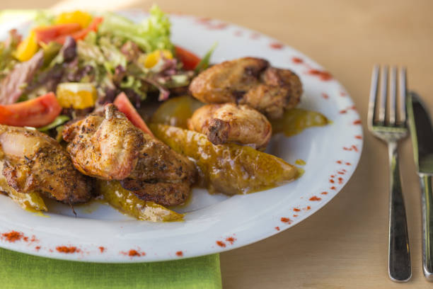 istock Grilled chicken on a white plate with vegetables on the background. 1286508107
