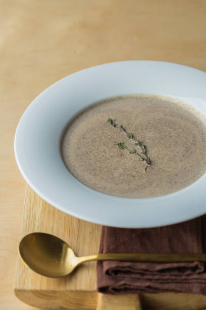 mushroom cream soup in a white  plate. cream of champignon soup - stater imagens e fotografias de stock