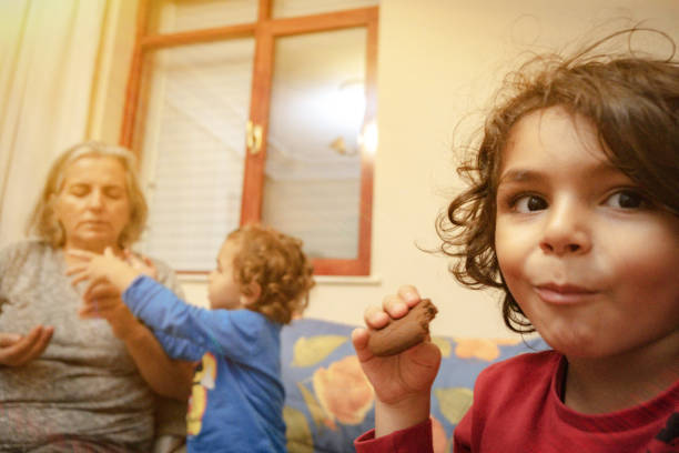 istock The crafty boy is eating cookies. 1286508929