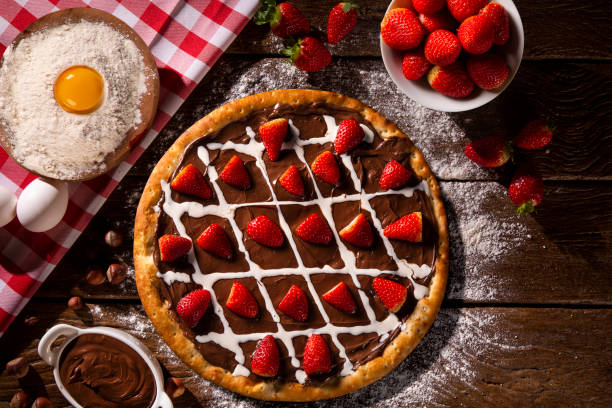 istock brazilian sweet pizza with hazelnut cream and strawberry on wood background. 1286512607