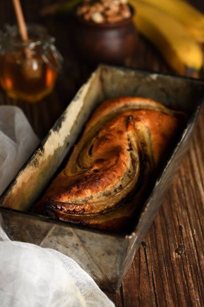 istock Freshly baked homemade banana bread.  An appetizing, delicate, soft bread texture, with crushed nut and honey aroma. 1286518390