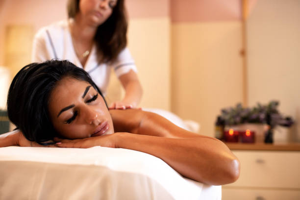 istock Beautiful dark tanned woman in a massage studio 1286518464