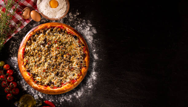 istock Various vegetables at wooden rustic background with copyspace on round pizza desk. Set of fresh vegetables. Egg, tomatoes, pepper, lettuce, onion, garlic, onion. Pizza ingredients. 1286518485