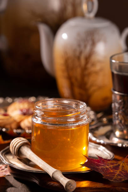 istock Tasty honey stick and a glass jar 1286518518