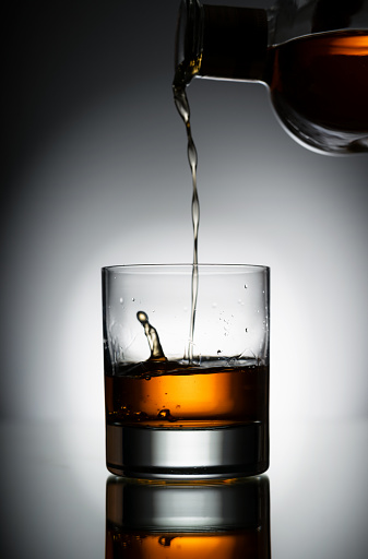 Pouring a glass of Scotch.