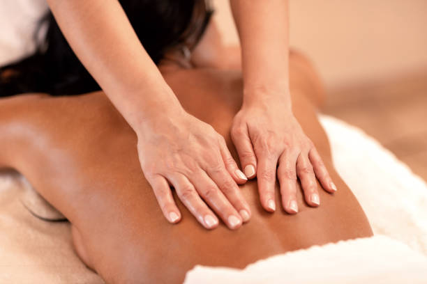 istock Woman lying on her chest in massage studio 1286518734