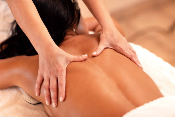 istock Woman lying on her chest in massage studio 1286518852