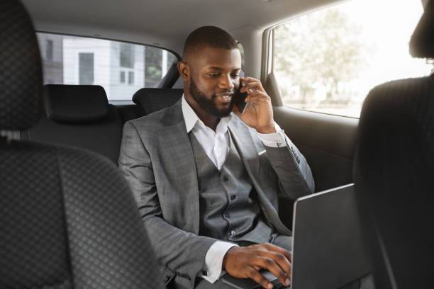 istock Happy black businessman talking on mobile phone in car 1286519548