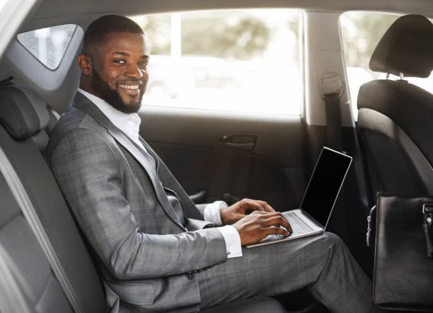 istock Smiling black guy businessman working on laptop with blank screen 1286519600