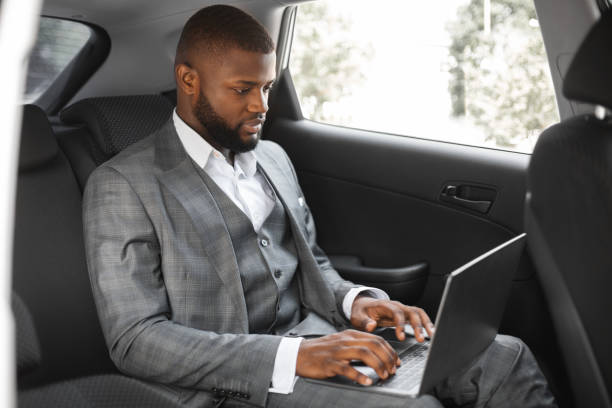 istock Successful african american entrepreneur working on laptop in car 1286520201