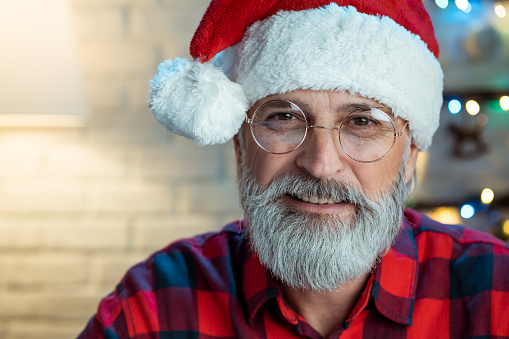 Happy senior man wearing Santa's hat