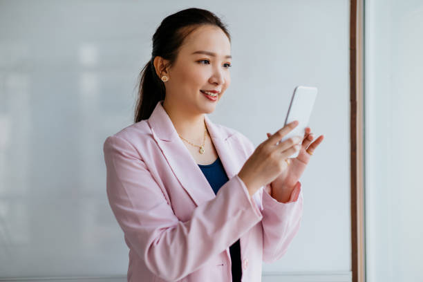 istock An Asian Chinese businesswoman using smart phone at office 1286521899