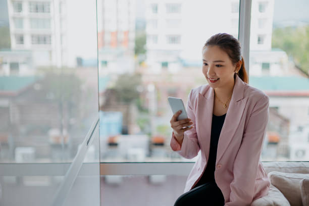 istock An Asian Chinese businesswoman using smart phone at office 1286521901