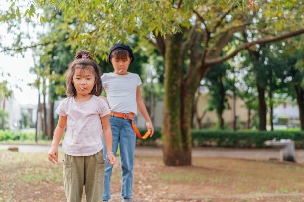 istock Sisters playing and enjoying walking in public park 1286522089
