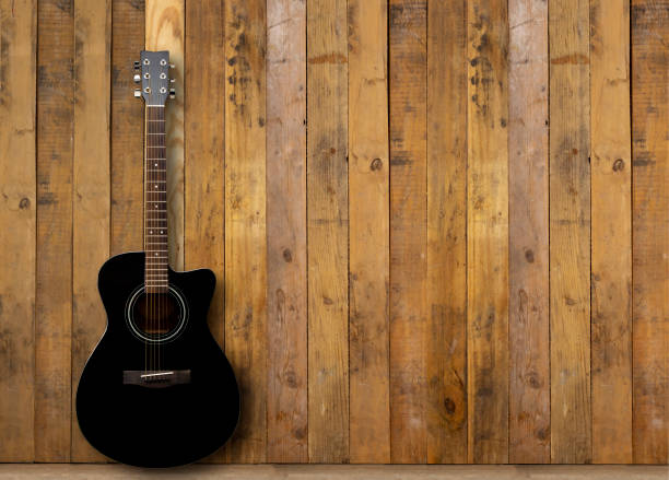 istock A black acoustic guitar on a wooden floor 1286522126