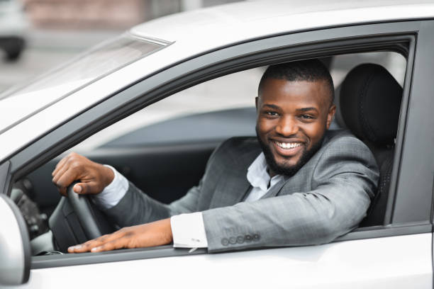 istock Happy businessman driving home after working day 1286523630