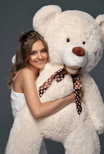 Photo of Beautiful happy woman with teddy bear