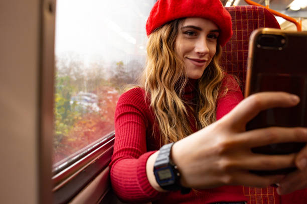 istock Young smiley girl taking a selfie on the train 1286523799