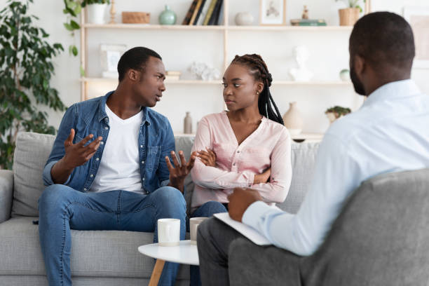 istock Young Black Spouses Having Relationship Problems, Sitting At Therapy Session With Counselor 1286524998