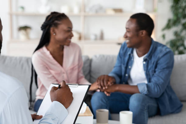istock Marriage counselor taking notes after successful therapy session with happy black couple 1286525014