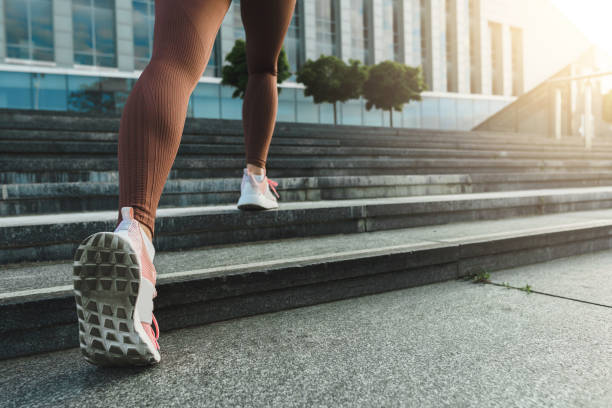 istock Woman running upstairs by a staircase during  jogging workout 1286525812