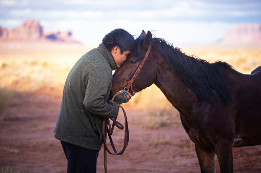 Navajo teen showing it love for his horse