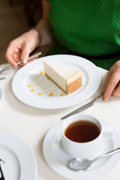 istock Woman eating cheese cake with cup of tea 1286528038