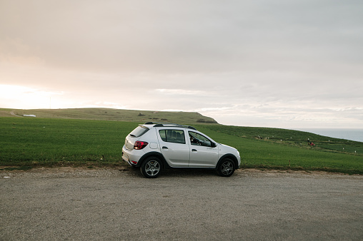 Cobreces, Spain - 22 October 2020: A Dacia Sandero compact car parked by a green field in Cobreces, Spain. It is the Stepway version