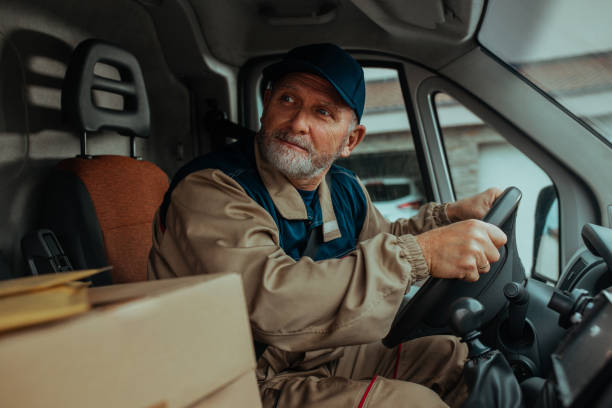 istock Delivery man driving his van and delivering shipments 1286528390