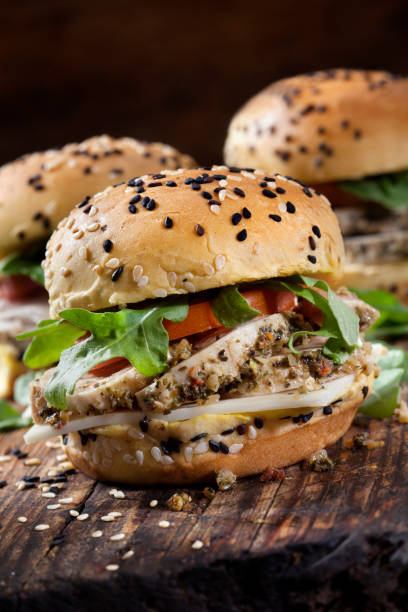 Roast Pork Sliders with Swiss Cheese, Tomato and Arugula on Brioche Sesame Seed Buns