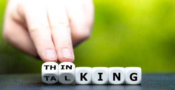 istock Symbol for thinking first and then talking. Hand turns dice and changes the word 