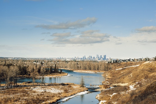 A view of the bow river with downtown Calgary in the background.