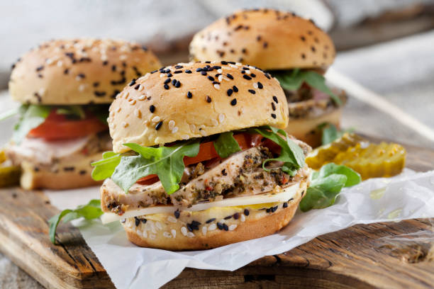 Roast Pork Sliders with Swiss Cheese, Tomato and Arugula on Brioche Sesame Seed Buns