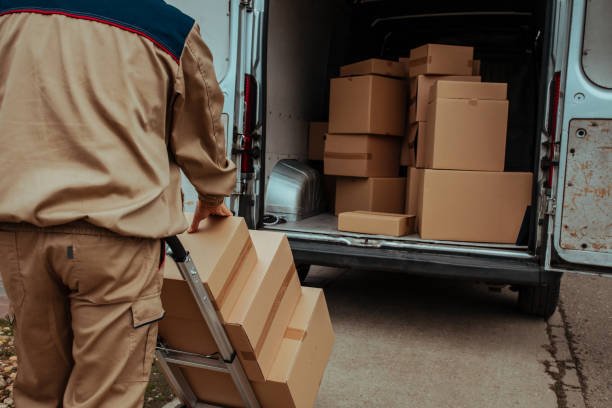 delivery man packing cardboard boxes in van - distribution warehouse freight transportation messenger box imagens e fotografias de stock