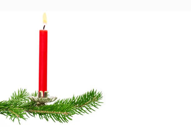 istock Fir branch with red candle isolated on a white background 1286530684